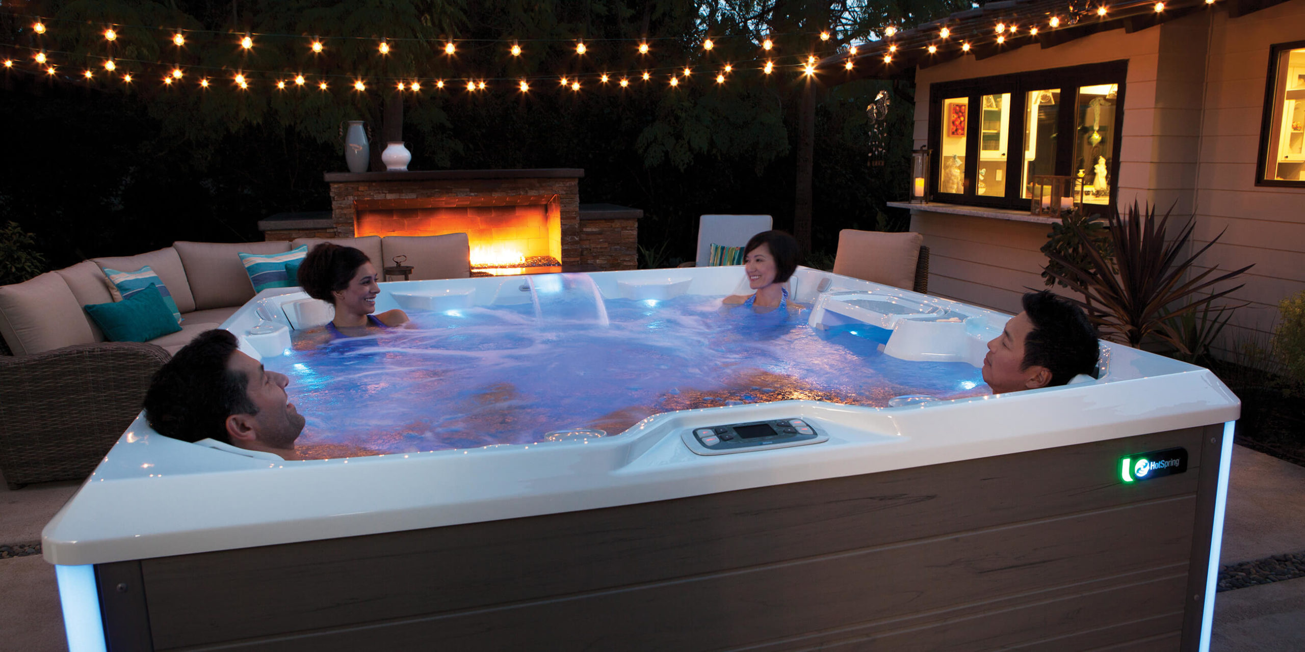 hot-spring-spas-limelight-collection-page-cspot-lifestyle-night-group-in-spa-1-scaled