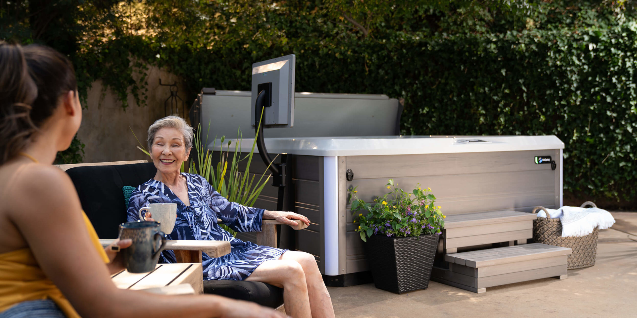 hot-spring-spas-limelight-collection-page-cspot-lifestyle-women-sitting-near-spa-1-scaled